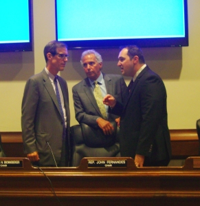 State Sen. William Brownsberger (left) and Rep. John Fernandes (center) confer during a Judiciary Committee hearing last June on H. 1459 and related bills. The Committee has subsequently taken no action on the bill.